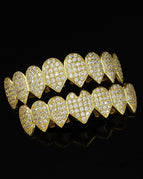 picture: heart-shaped pointed gold upper and lower teeth